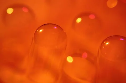 Abstract Orange Bubbles and Capsules in Warm Light Stock Photos