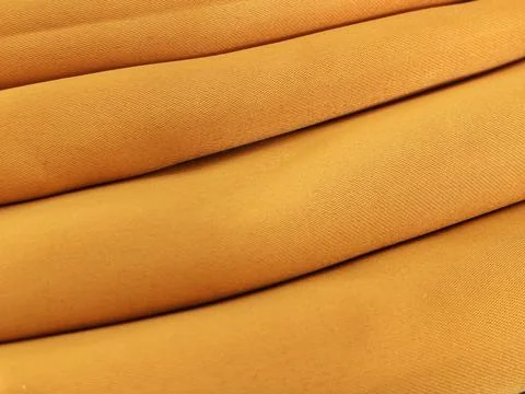 Abstract Orange Fabric Texture with Soft Folded Textile Background Stock Photos