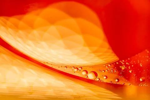 Abstract orange liquid with bubbles, creating a dynamic and vibrant texture.. Stock Photos