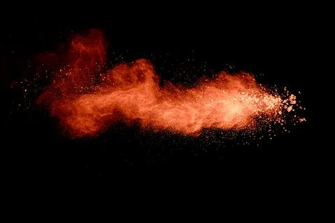 Abstract orange powder explosion on black background. Freeze motion of oran.. Stock Illustration