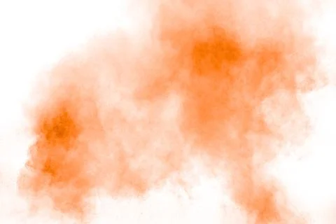 Abstract orange powder explosion on white background. Freeze motion of oran.. Stock Photos