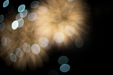 Abstract out of focus bokeh lights creating golden festive circles on dark .. Stock Photos