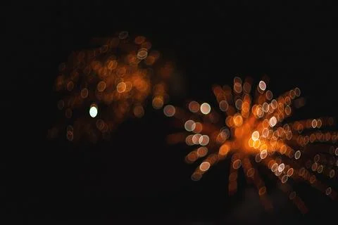 Abstract out of focus bokeh lights creating golden festive circles against .. Stock Photos