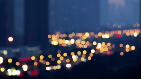 Abstract Out of Focus City Lights Bokeh at Night with Dark Building Silhouettes Stock Footage 331834779