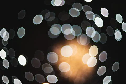 Abstract out of focus fireworks light bursts glowing in the dark night sky Stock Photos