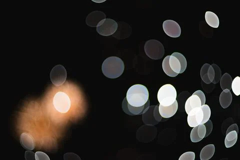 Abstract out of focus sparkling lights and glowing bokeh circles against a .. Stock Photos