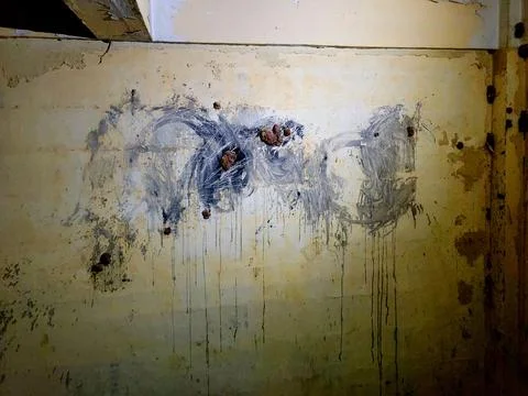 Abstract paint drips streak down a weathered, yellowed wall Stock Photos