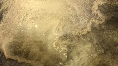 Abstract paint ink in motion. Streams of translucent gold and bronze shades Stock Footage 155246922