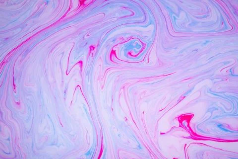 Abstract paint ink, psychedelic background. Colorful spots on water surface. Stock Photos