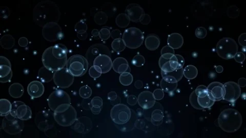Abstract particle floating loop with bokeh bubbles glowing on dark backdrop.. Stock Footage 345574308