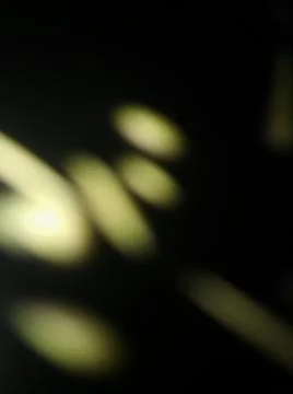 Abstract particles in black background with different elements in blurry effe Stock Photos
