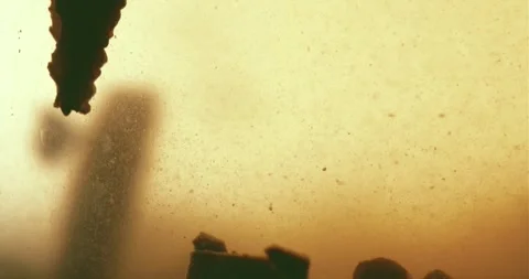 Abstract Particles Falling into a Liquid Stock Footage 274955343