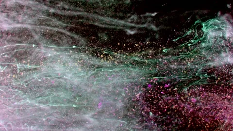 Abstract particles in multicolor liquid flow and float motion on black Stock Footage 138592380
