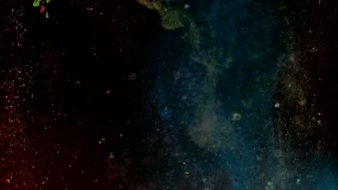 Abstract particles in multicolor liquid flow and float motion on black Stock Footage 138592972