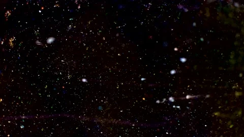 Abstract particles in multicolor liquid flow and float motion on black Stock Footage 138594278