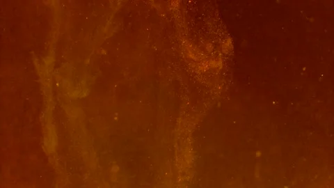 Abstract particles of orange liquid flow and float motion on black Stock Footage 138593491