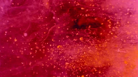 Abstract particles of pink and orange liquid flow and float motion on black Stock Footage 138592111