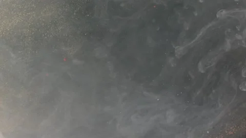 Abstract particles of pink and silver liquid flow and float motion on black Stock Footage 138593225