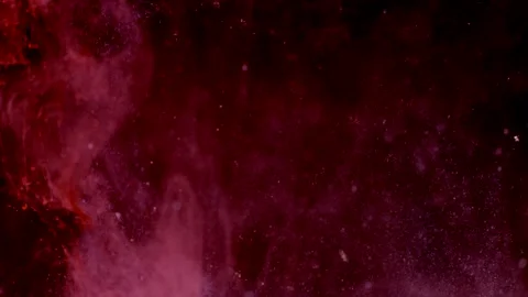Abstract particles of pink liquid flow and float motion on black Stock Footage 138592621