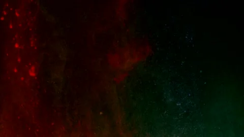 Abstract particles of red and green liquid flow and float motion on black Stock Footage 138595345