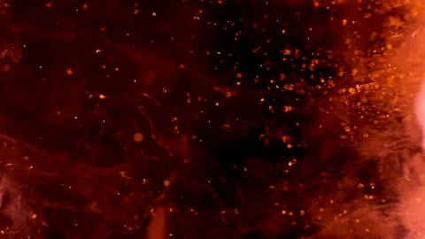 Abstract particles of red and orange liquid flow and float motion on black Stock Footage 138592350