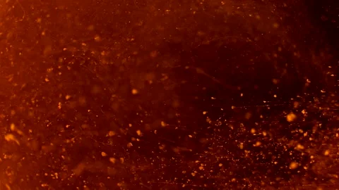 Abstract particles of red and orange liquid flow and float motion on black Stock Footage 138592395