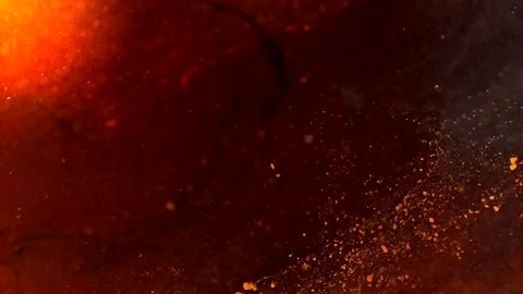 Abstract particles of red and orange liquid flow and float motion on black Stock Footage 138593942
