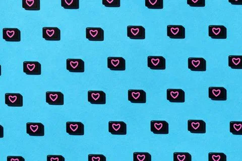 Abstract pattern of black beads with pink heart on blue background. St Stock Photos