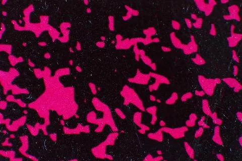 Abstract pattern of bright pink shapes on black background texture Stock Photos