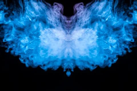 Abstract pattern of colored smoke backlit blue and turquoise takes the form o 스톡 사진