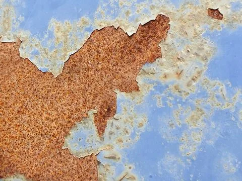 Abstract pattern created by blue cracked paint and rust on a sheet of metal Foto stock