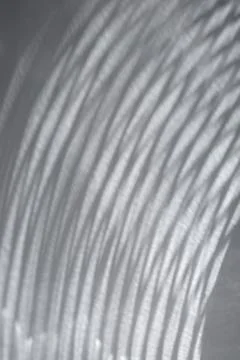Abstract pattern of curved light shadows on gray surface Stock Photos