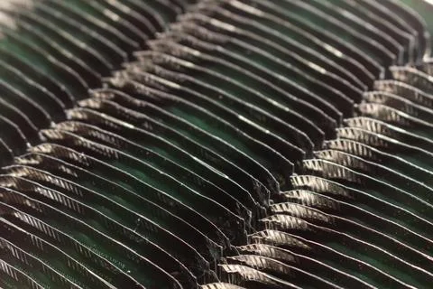 Abstract pattern of dark green metallic foil sheets stacked in rows Stock Photos