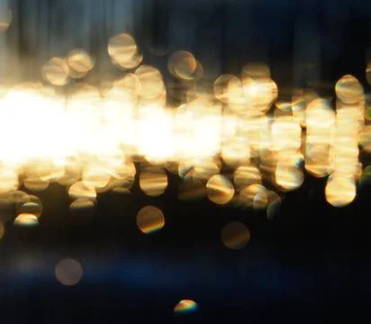 Abstract pattern de-focused points of golden light against the dark blue Stock Photos