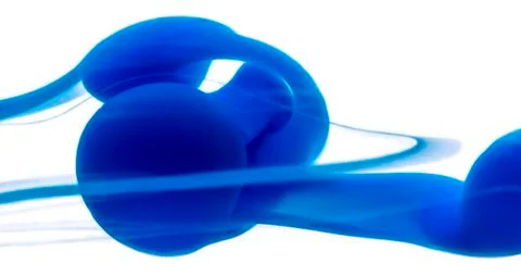 Abstract pattern falling into the water drop of blue ink Stock Photos