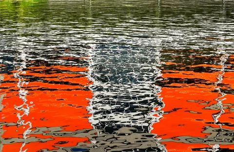 Abstract pattern formed by the reflection. of a building on the rippled water 写真素材