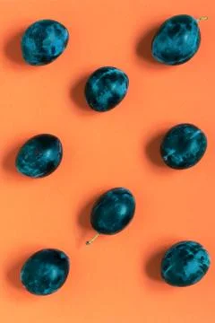 Abstract pattern fresh plums on orange background Stock Photos