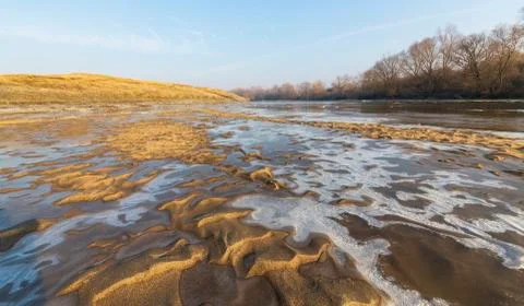 Abstract pattern with fresh snow on a sandy river beach 写真素材