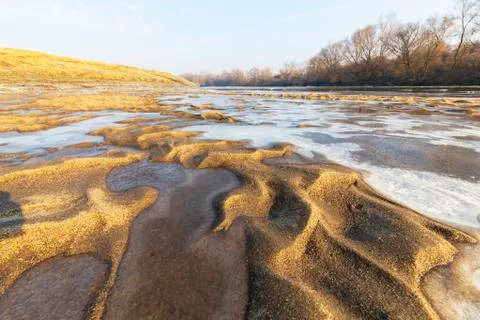 Abstract pattern with fresh snow on a sandy river beach 写真素材