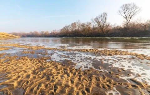Abstract pattern with fresh snow on a sandy river beach 写真素材