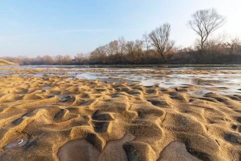Abstract pattern with fresh snow on a sandy river beach 写真素材