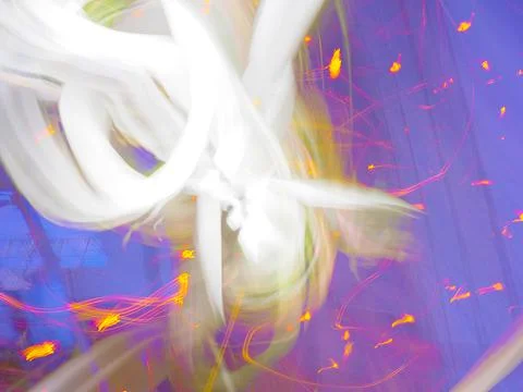 Abstract pattern of golden firework light streaks against a blue purple Stock Photos