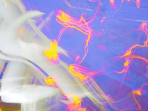 Abstract pattern of golden firework light streaks against a blue purple Stock Photos