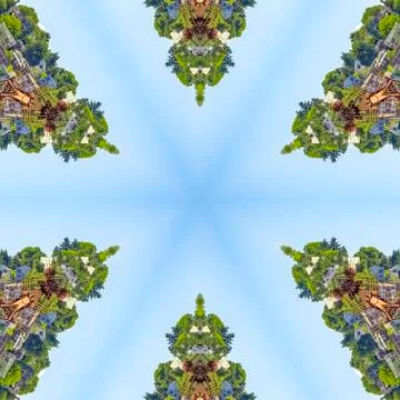 Abstract pattern of homes and foliage against blue Foto stock