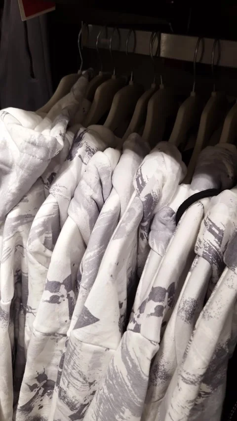 Abstract Pattern Hoodies Hanging on a Retail Clothing Rack Stock Footage 326061305