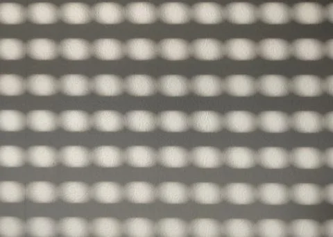 Abstract Pattern of Light and Shadows on a Textured Surface for Creative Desi Stock Photos