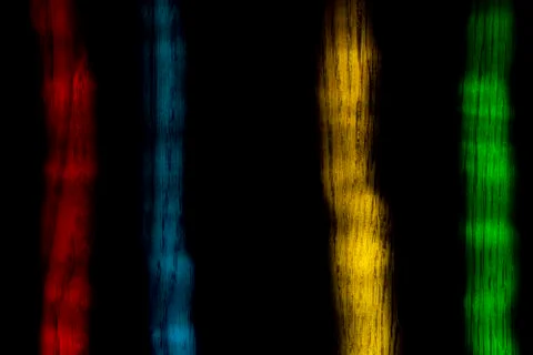 Abstract pattern. Light effect. Multicolored lines on a dark background wooden Foto stock