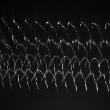 Abstract pattern of light shining on coiled metal, length of fine wire woun.. Stock Photos