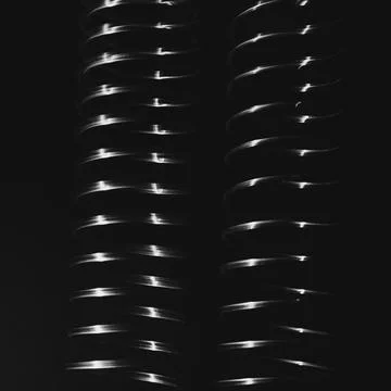 Abstract pattern, light shining on a length of fine wire wound around and s.. Stock Photos