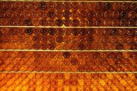 Abstract pattern made from lots of orange coloured wine bottles Stock Photos